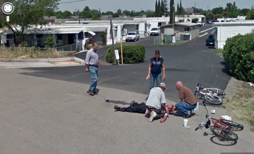A man lies on the street in the aftermath of a road accident caught by Google Street View