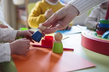 Preschool children playing with colorful shapes