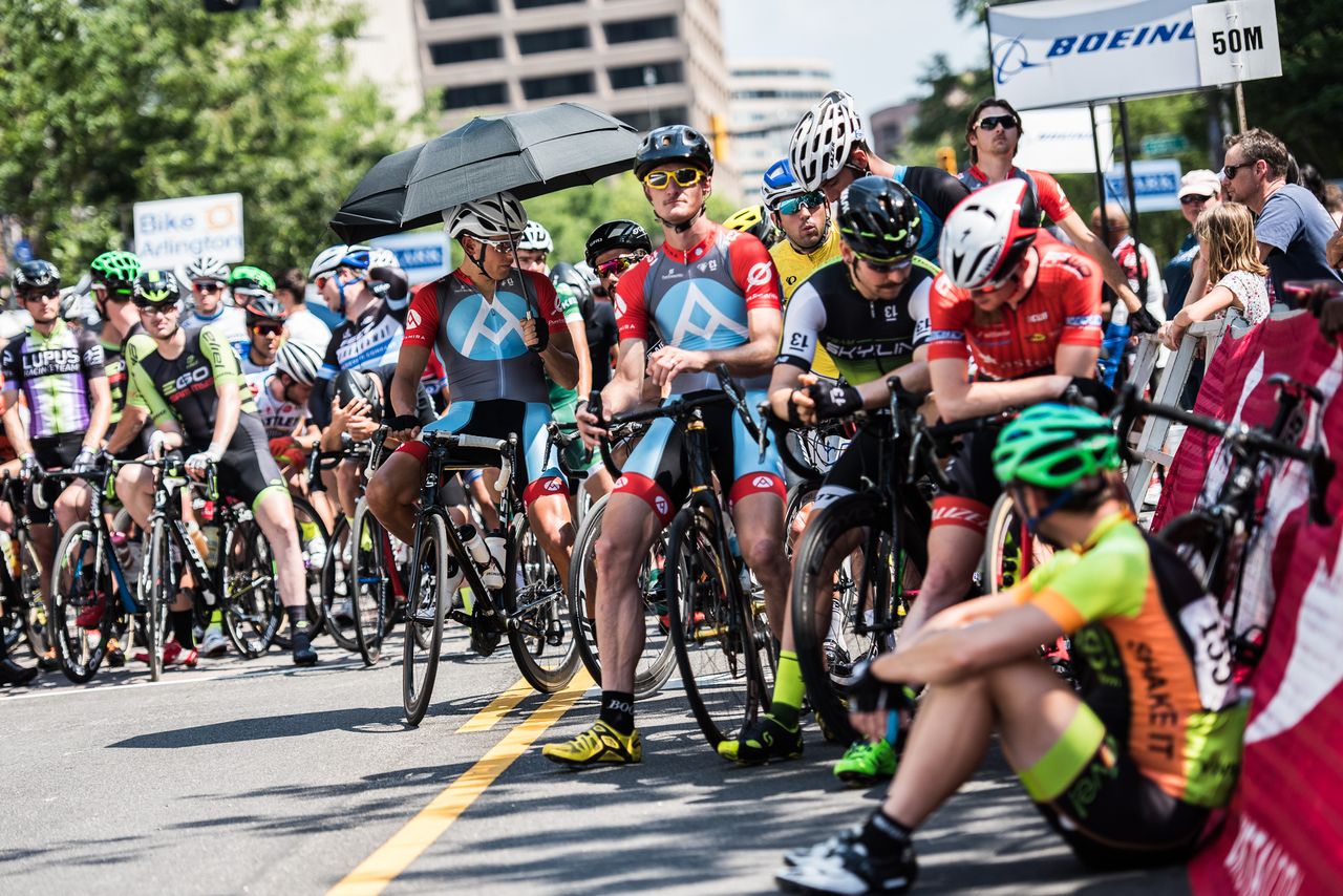 Riders try to find shade wherever they can at the start