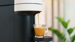 a pod coffee machine pouring an espresso shot