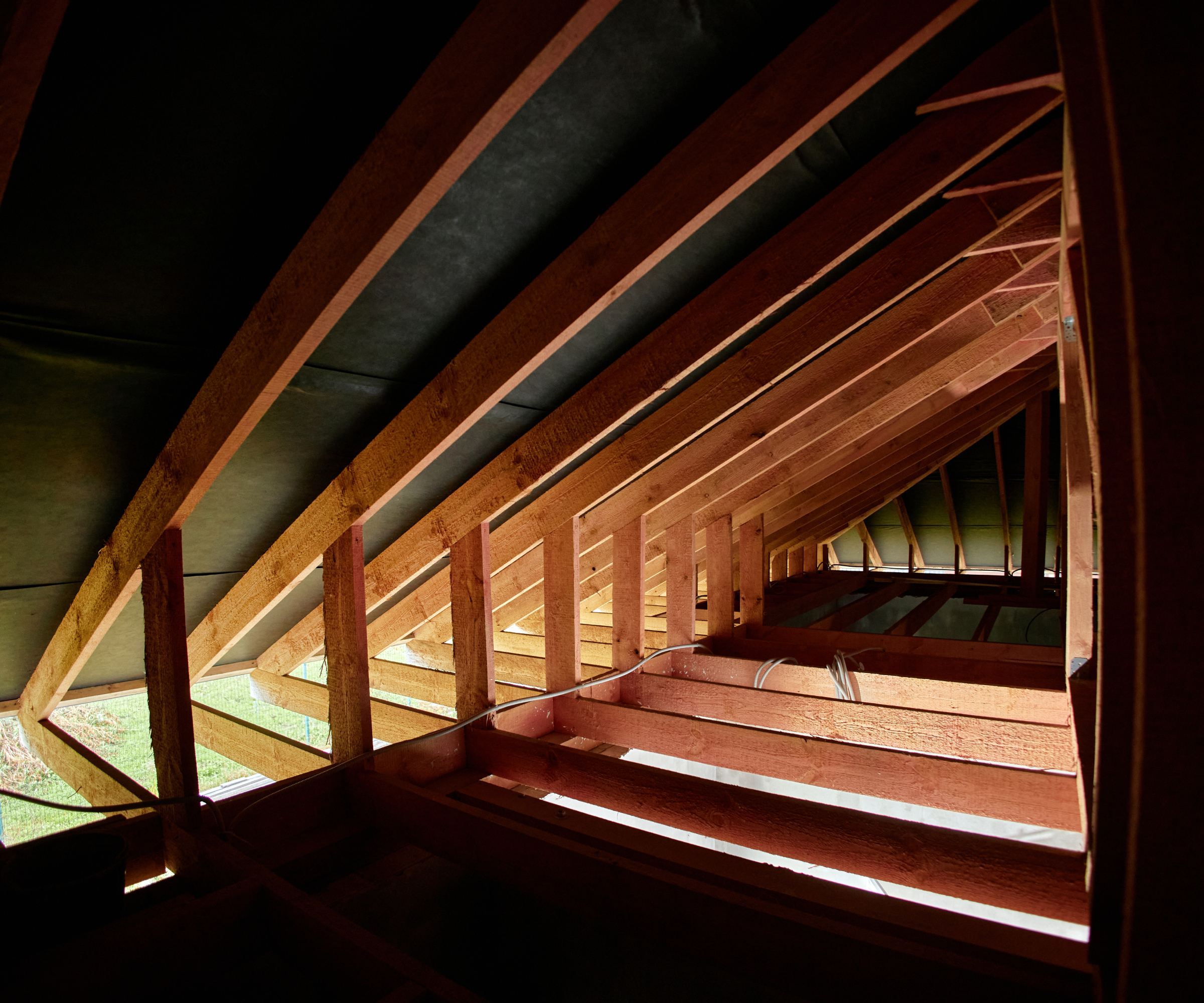 Roof frame shown from within an unfinished loft space