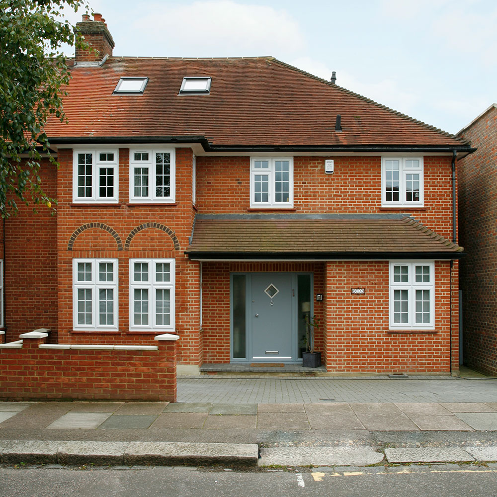 exterior of house with brick wall sash window and grey door