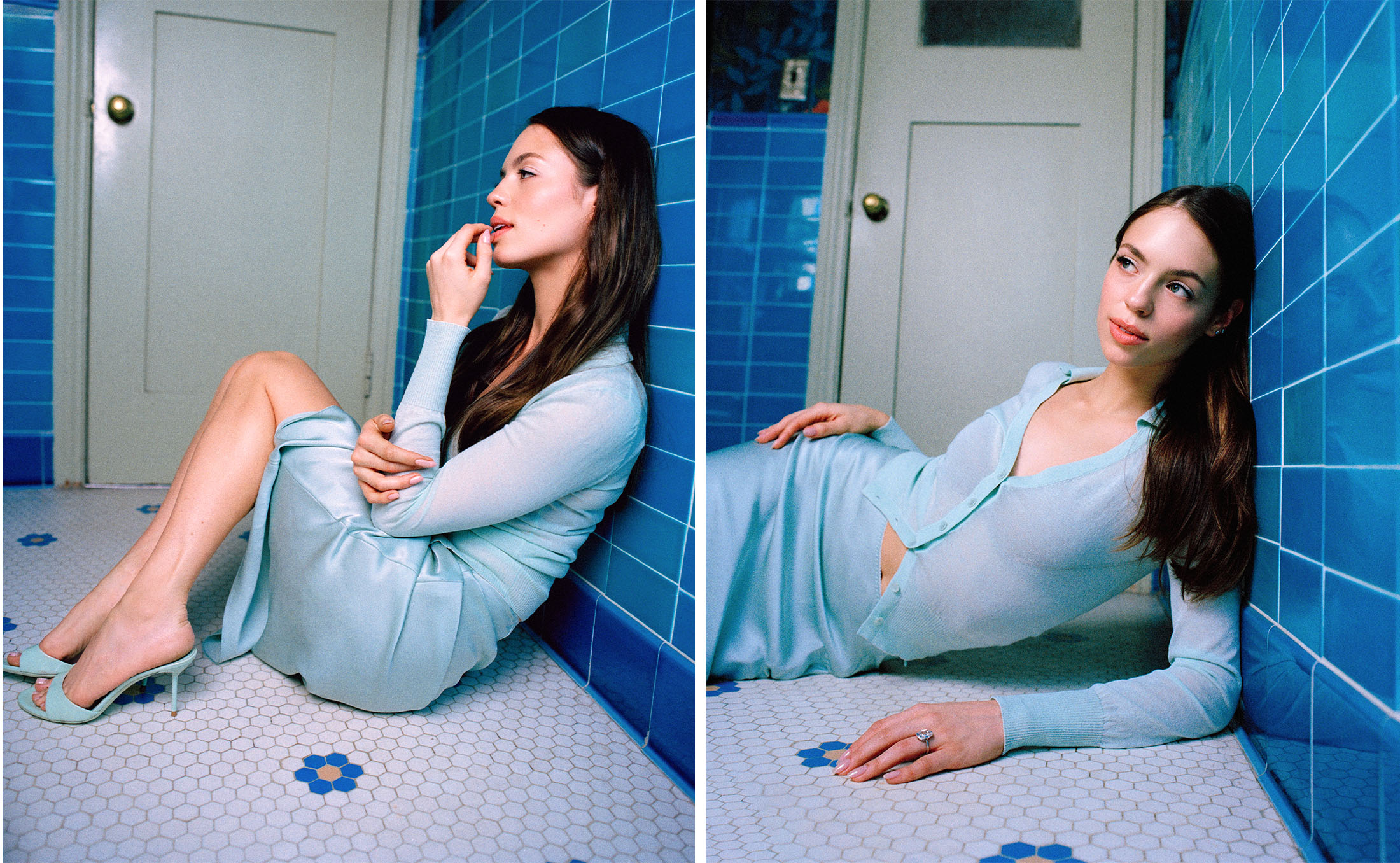 Claudia Sulewski sitting on a bathroom floor in a blue cardigan, a matching blue silk skirt, and mules.