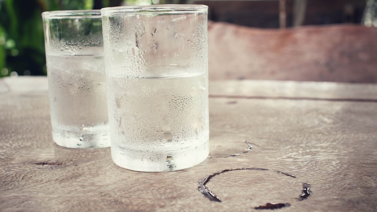 Glasses of water on table with water stains