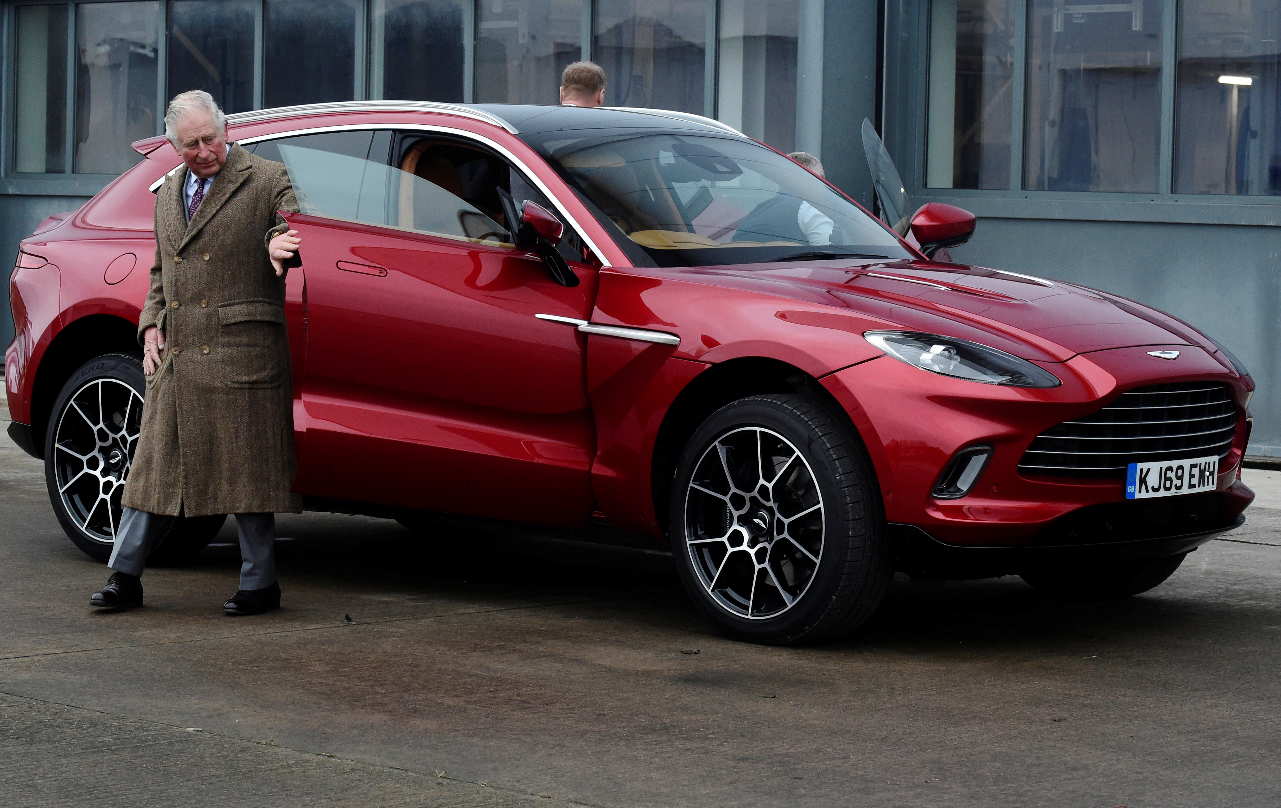 BARRY, WALES - FEBRUARY 21: Prince Charles, Prince of Wales drives Aston Martin's first SUV the Aston Martin DBX during his visit to the new Aston Martin Lagonda factory on February 21, 2020 in Barry, Wales.