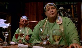 The Island of Dr Moreau Marlon Brando sitting in front of glasses of wine