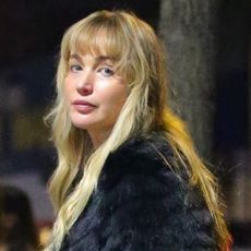 Jennifer Lawrence is spotted out and about in New York, wearing a black t-shirt and jeans and accessorizing it with black fur and a red leather bag.