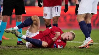 Erling Haaland down injured in Norway's game against Faroe Islands in November 2023.