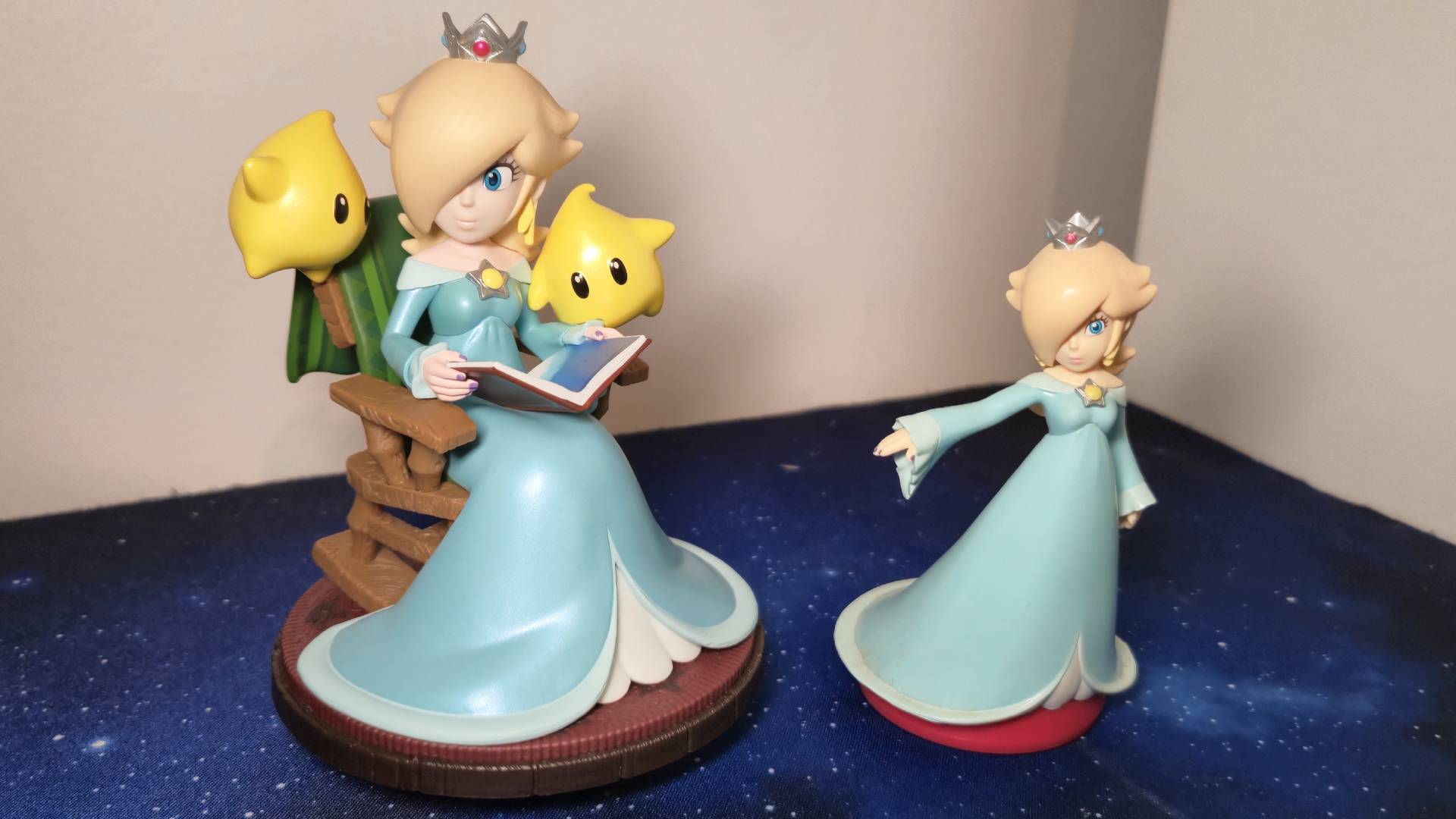 Photo of the Super Mario Galaxy Rosalina and Luma amiibo next to the Super Mario Party Rosalina amiibo for scale.