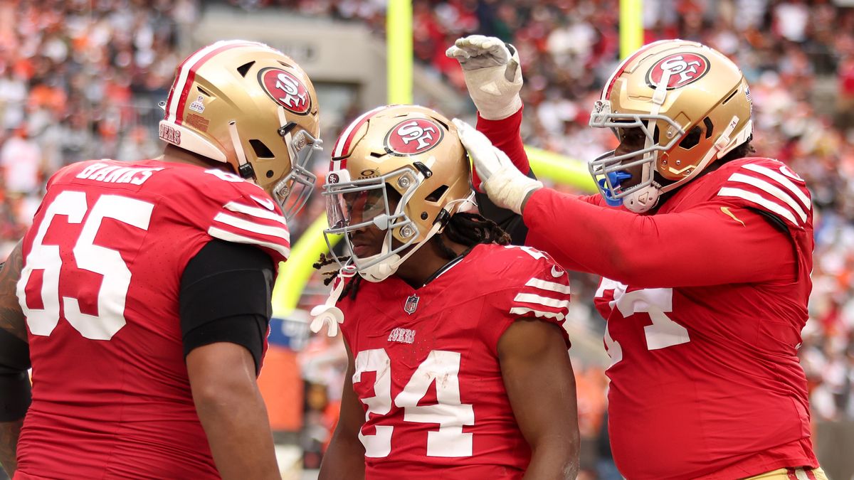 Jordan Mason #24 of the San Francisco 49ers celebrates with teammates before the 49ers vs Jaguars NFL game.