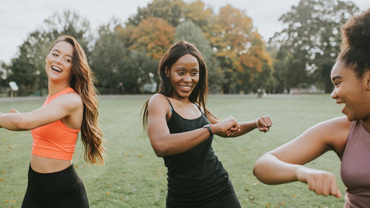 Three people exercising in a park