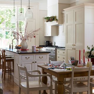 kitchen room with white wall and dining table with chairs