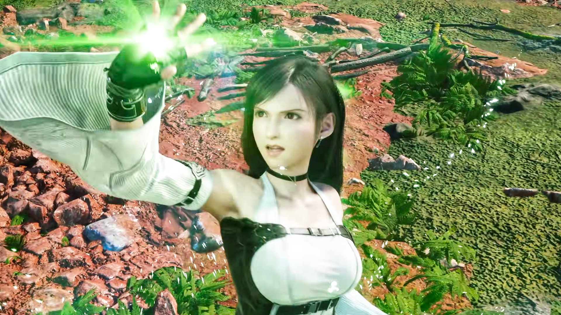 A screenshot of Final Fantasy 7 Revelation character Tifa reading a magical green spell as a black mage.