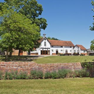 exterior of house garden with brick wall and trees