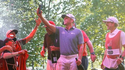 Talor Gooch films himself for an Instagram story while celebrating his LIV team win