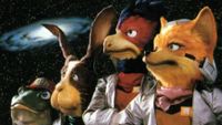 From left to right, puppet versions of Slippy, Peppy, Falco, and Fox from Star Fox looking to the left with a galaxy visible in the background.