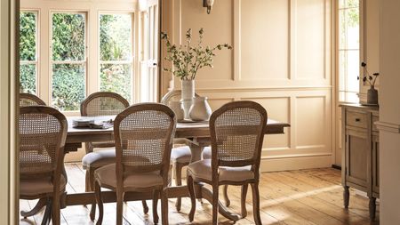 A dining room with an oak dining table and four chairs