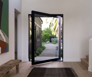 California modern home entryway with large glass door to let in plenty of natural light
