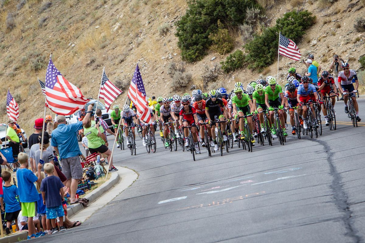 Fans cheer as the peloton comes through.