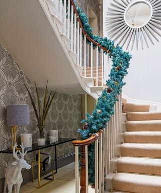 staircase decoration with draping garlands and round mirror