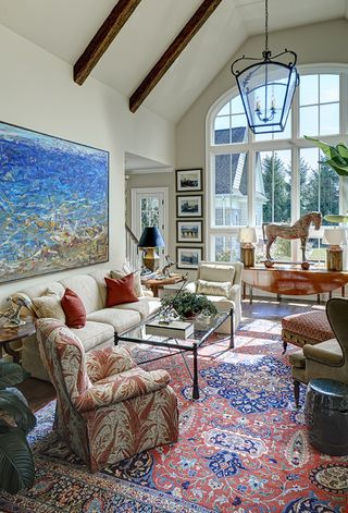 traditional living room wiht feature window and antique rug and furniture