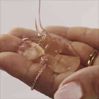 Hair product being poured into hand.