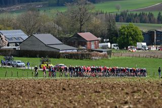 A general view of the peloton passing through a landscape during the 8th Liege - Bastogne - Liege Femmes 2024 a 152.9km one day race from Bastogne to Liege