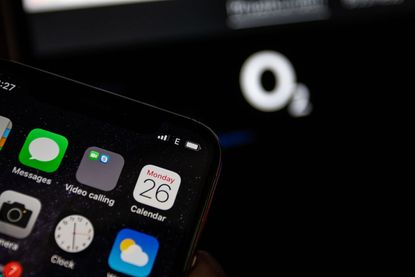 Close up of smartphone with O2 logo in the background