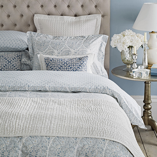 bedroom with round table with table lamp