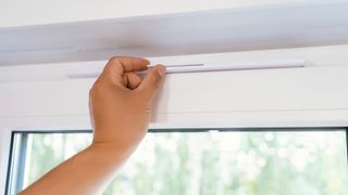 hand opening trickle vent on white uPVC window frame