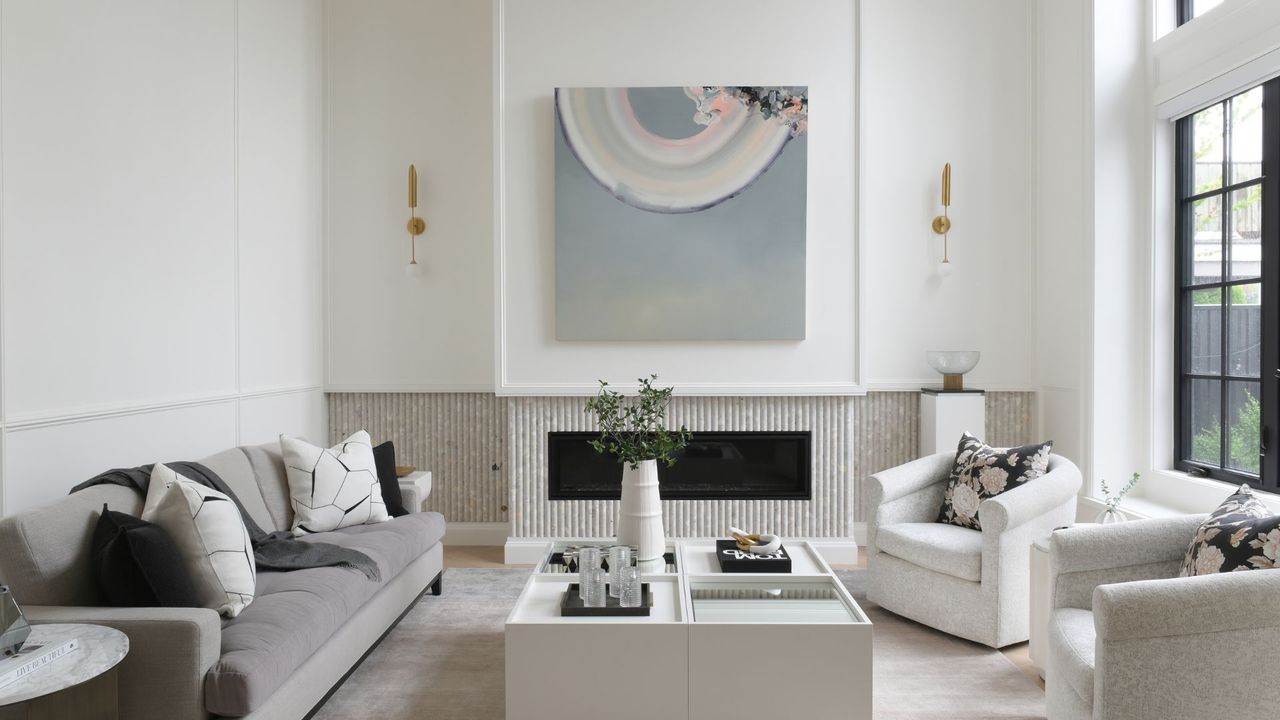 living room with cream walls and furniture and high steel framed windows