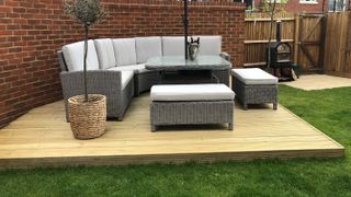 corner deck in garden with outdoor sofa
