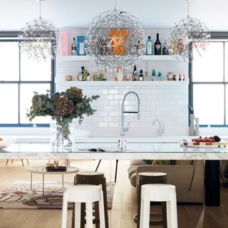 white kitchen with walled shelves and flower vase