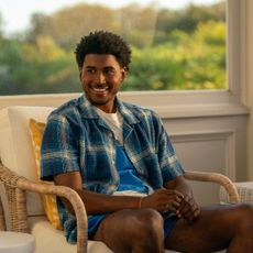 Michael Cooper Jr. as Justin Edwards, sitting in a wicker chair in a sunroom, in Episode 105 of Forever.