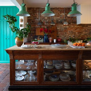 old glass-fronted haberdashers cabinet upcycled as a kitchen island