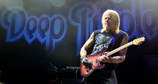 Steve Morse plays live with Deep Purple and takes a solo on on his signature Ernie Ball Music Man, with the band's logo visible in the background