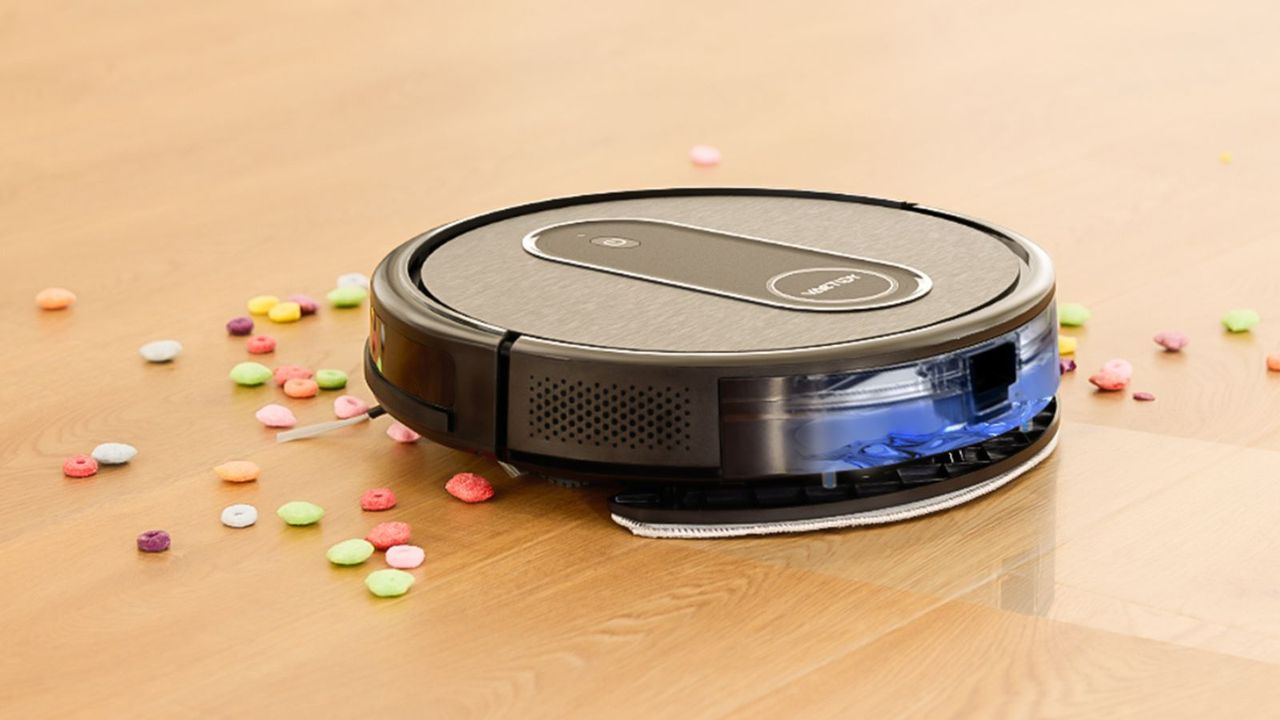 VacTidy Nimble T7 on a wooden floor, cleaning up spilled cereal.