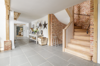 curved brick and wood staircase in modern home