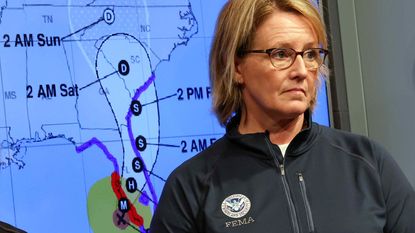 picture of the FEMA administrator in front of a map showing Hurricane Ian's path