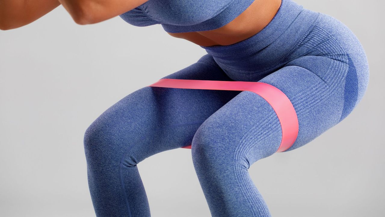 A woman doing one of the best resistance band workouts for beginners at home