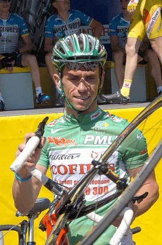 Jimmy Casper (Cofidis) wheels his bike away from sign on
