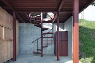 red metal staircase leading inside japanese tiny house