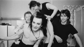 The Damned horsing around backstage in 1986