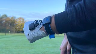 The HackMotion Golf Swing Analyzer on a golfer's hand on the golf course