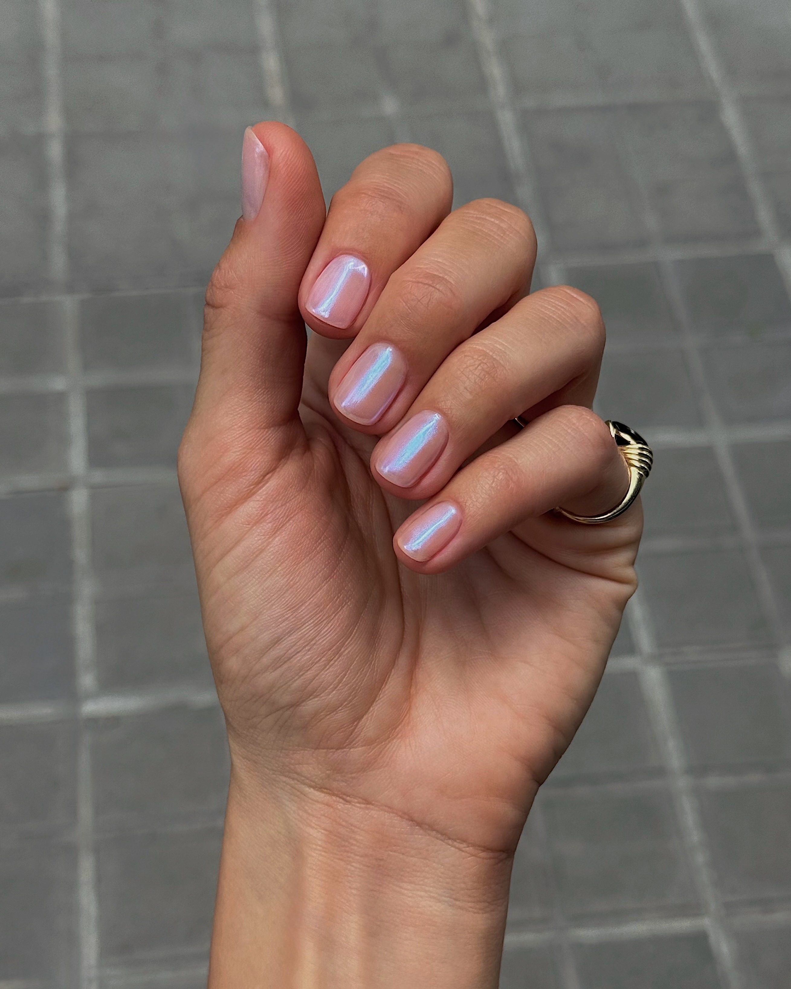A close-up of a blue chrome manicure