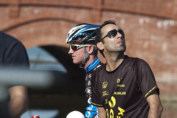Help from above: A Giant Asia crew member looks to the heavens in hope of a reprieve for rider Jai Crawford (left) who was left at the startline unable to take his place on the tour.