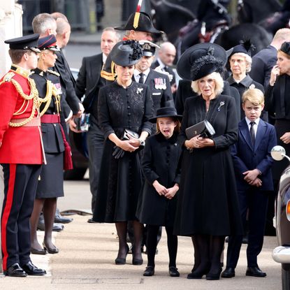 Camilla, Queen Consort, Prince George of Wales, Catherine, Princess of Wales, (obscured) Princess Charlotte of Wales and Sophie, Countess of Wessex watch the funeral procession as it passes through Wellington Arch during the state funeral of Queen Elizabeth II on September 19, 2022 in London, England. Elizabeth Alexandra Mary Windsor was born in Bruton Street, Mayfair, London on 21 April 1926. She married Prince Philip in 1947 and ascended the throne of the United Kingdom and Commonwealth on 6 February 1952 after the death of her Father, King George VI. Queen Elizabeth II died at Balmoral Castle in Scotland on September 8, 2022, and is succeeded by her eldest son, King Charles III.