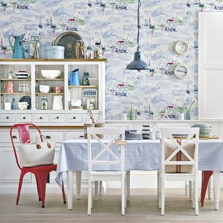 dinning room with blue designed wall dinning table and chairs and hanging limp