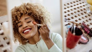 woman applying makeup