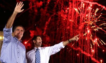 Republican red fireworks explode behind Mitt Rommney and Paul Ryan drying a Victory Rally in Daytona Beach, Fla. on Oct. 19.
